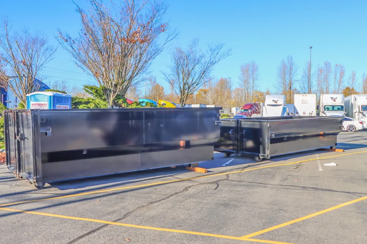 Professional dumpster rental service with roll-off container on residential driveway in Rockdale